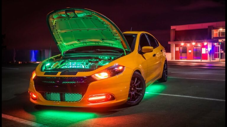 A vibrant yellow car with neon green lights under the hood